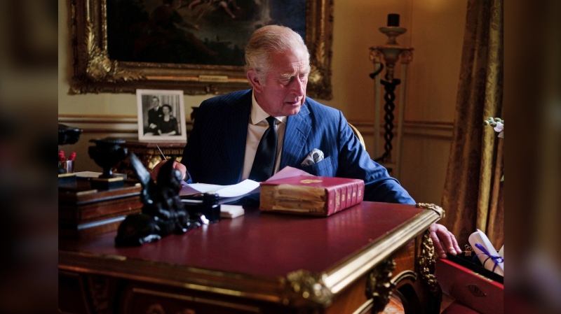 In this photo Sept. 11, 2022, taken King Charles III carries out official government duties from his red box in the Eighteenth Century Room at Buckingham Palace, London. (Victoria Jones/PA via AP)