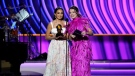Emily Bear, left, and Abigail Barlow accept the award for best musical theatre album for "The Unofficial Bridgerton Musical" at the 64th Annual Grammy Awards, April 3, 2022, in Las Vegas. (AP Photo/Chris Pizzello)