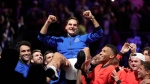 Team Europe's Roger Federer is lifted by fellow players after playing with Rafael Nadal in a Laver Cup doubles match against Team World's Jack Sock and Frances Tiafoe at the O2 arena in London, Sept. 23, 2022. (AP Photo/Kin Cheung)