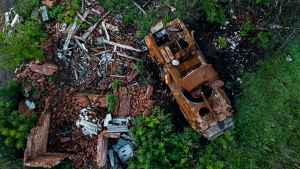 A destroyed APC lies on the ground in the recently retaken area of Kharkiv region, Ukraine, Friday, Sept. 23, 2022. (AP Photo/Evgeniy Maloletka)