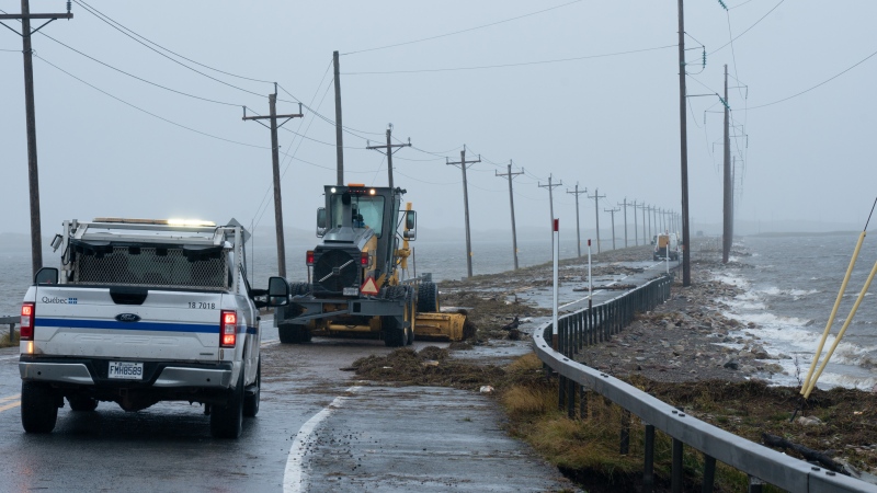 Highway crews clean debris caused by post-tropical storm Fiona on the Les Îles-de-la-Madeleine, Que., Saturday, Sept. 24, 2022. THE CANADIAN PRESS/Nigel Quinn