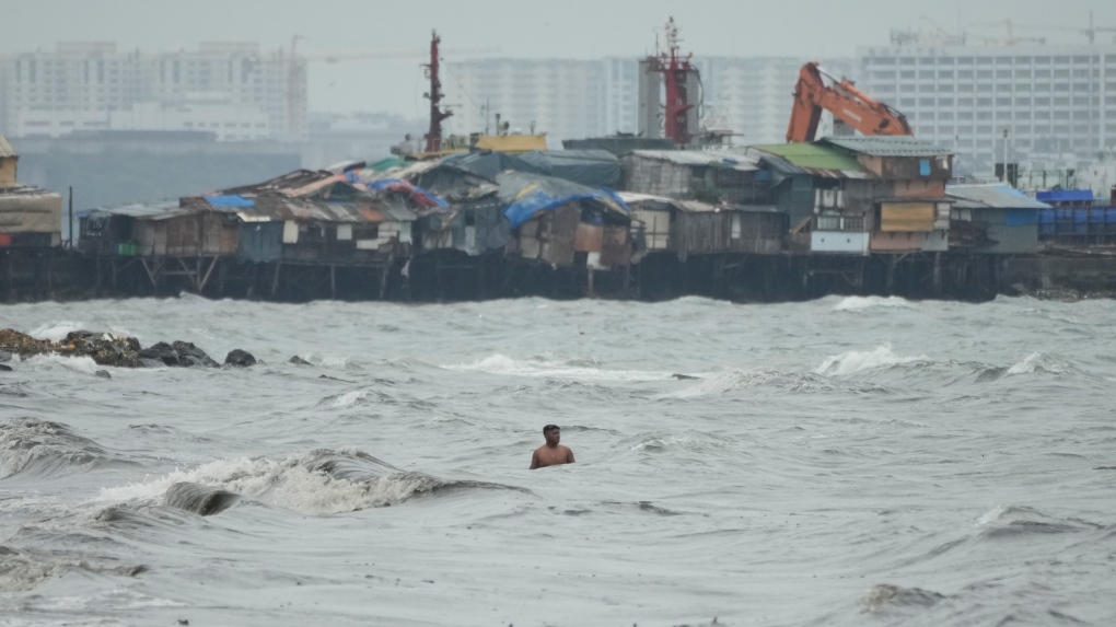 Resident swimming as Typhoon Noru approaches