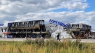 A man walks by a destroyed shopping centre in Bucha, Ukraine, on Sunday, Sept. 25, 2022. (AP Photo Karl Ritter)