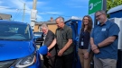 Acting Mayor Marianne Alto and David Grove from the Victoria Electric Vehicle Association plug in Victoria’s first neighbourhood electric vehicle fast charger in Victoria West on Saturday. (Photo: City of Victoria)
