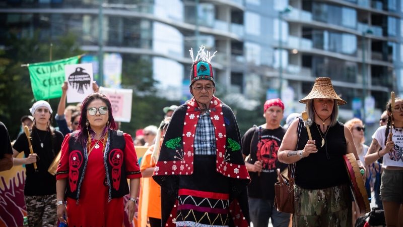 Wet'suwet'en Hereditary Chief Namoks (John Ridsdale), centre, leads a protest march against fracking in Vancouver, on Monday, August 15, 2022. THE CANADIAN PRESS/Darryl Dyck