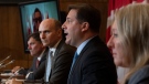 Minister of Intergovernmental Affairs Dominic LeBlanc, Health Minister Jean-Yves Duclos and President of the Treasury Board Mona Fortier listen to Public Safety Minister Marco Mendicino speak during a news conference, Monday, Sept. 26, 2022 in Ottawa. THE CANADIAN PRESS/Adrian Wyld