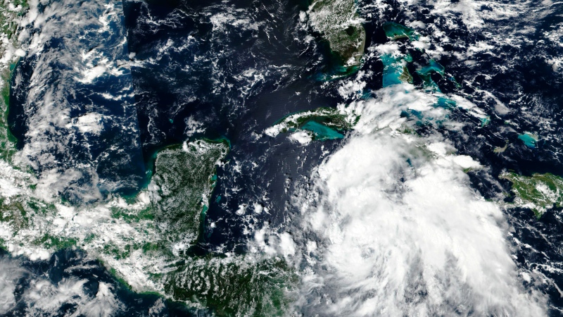 This Sept. 25, 2022 satellite image released by NASA shows Hurricane Ian over Caribbean Sea moving near the Cayman Islands and closer to western Cuba.  (NASA Worldview, Earth Observing System Data and Information System (EOSDIS) via AP)