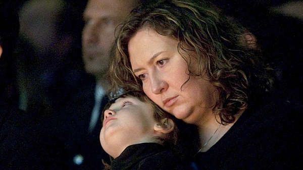 Anna Korutowska rests her head on son Anthony Czapnik during the funeral service Ottawa Police Const. Ireneusz Eric Czapnik in Ottawa, Thursday January 7, 2010. (Adrian Wyld / THE CANADIAN PRESS)