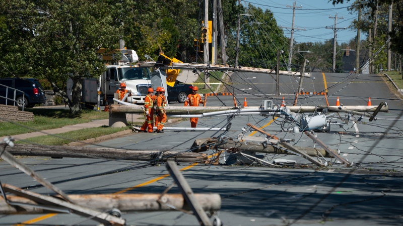 Workers assess downed power poles caused by post-tropical storm Fiona in Dartmouth, N.S. on Sunday, September 25, 2022. (Source: THE CANADIAN PRESS/Darren Calabrese)