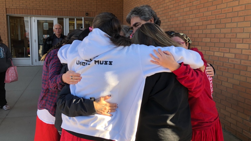 Megan Gallagher’s family shares an embrace on Sept. 26, 2022 after a man charged with first-degree murder appeared in court via telephone. (Pat McKay/CTV News)