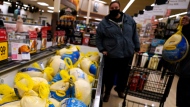 People shop for frozen turkeys for Thanksgiving dinner at a grocery store in 2021. In Canada, the per-kilogram cost of turkeys has increased by 15 per cent compared to last year. (AP photo/Nam Y. Huh)