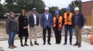 Officials including Education Minister Stephen Lecce pose for a photo at the construction site of the first licensed childcare centre in Thames Centre on September 26, 2022. (Brent Lale/CTV News London)