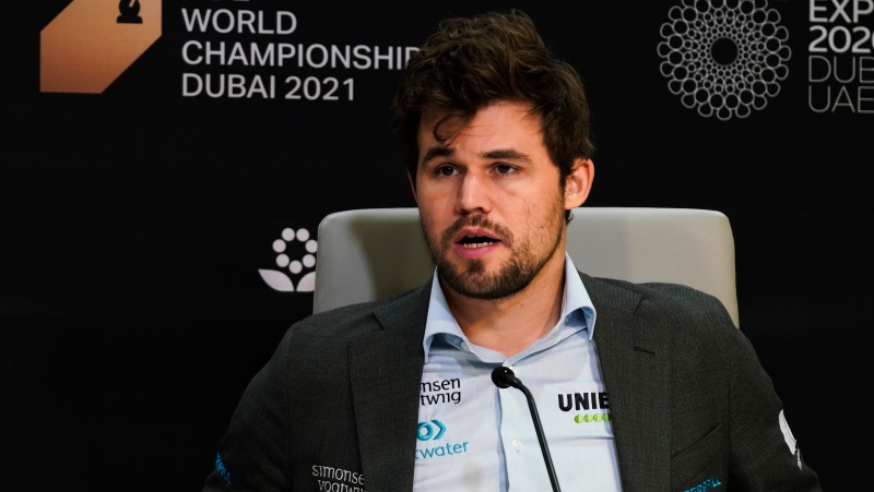 Magnus Carlsen of Norway attends a news conference after winning the FIDE World Championship at Dubai Expo 2020 in Dubai, United Arab Emirates, Friday, Dec. 10, 2021. (AP Photo/Jon Gambrell)