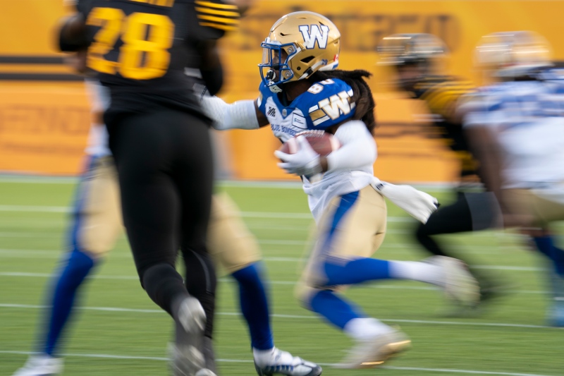 Winnipeg Blue Bombers wide receiver Janarion Grant (80) runs back a punt against the Hamilton Tiger Cats during second half CFL football game action in Hamilton, Ont. on Saturday, September 17, 2022. THE CANADIAN PRESS/Peter Power