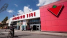 A man cycles by a Canadian Tire store in North Vancouver on May 10, 2012. THE CANADIAN PRESS/Jonathan Hayward
