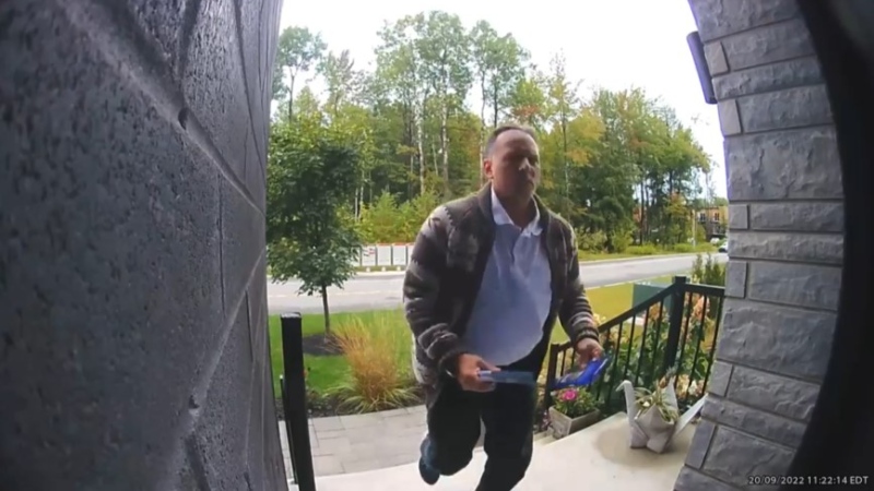 Video footage shows a volunteer for the Parti Quebecois about to remove a CAQ flyer from an elector's home on Sept. 20, 2022. (Screencapture)