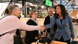 Quebec Liberal Leader Dominique Anglade, right, shakes hand with a shopper at a local farmer's market, Tuesday, Sept. 27, 2022 in Quebec City. Quebecers are going to the polls for a general election on Oct. 3rd. (THE CANADIAN PRESS/Jacques Boissinot)
