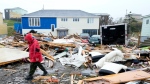 A Canadian Forces Ranger walks through the devastation of destroyed properties in Port aux Basques, N.L., Monday, Sept. 26, 2022. Across the Maritimes, eastern Quebec and in southwestern Newfoundland, the economic impact of hurricane Fiona’s wrath is still being tallied. THE CANADIAN PRESS/Frank Gunn