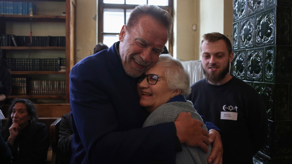 Arnold Schwarzenegger hugs Holocaust survivor