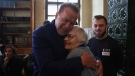Arnold Schwarzenegger, left, hugs Holocaust survivor Lydia Maksimovicz, right, in Oswiecim, Poland, Wednesday, Sept. 28, 2022. (AP Photo/Michal Dyjuk)