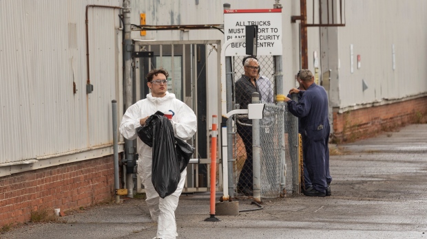 Employees of THK Rhythm Automotive plant wait outside of the St. Catharines, Ontario facility Tuesday, September 27, 2022. An acid spill at an auto plant sent 23 people to a Niagara Region hospital on Tuesday, including three who were directly exposed to the hazardous material, but all were expected to be discharged later in the day. THE CANADIAN PRESS/Tara Walton