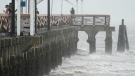 Waves crash along the Ballast Point Pier ahead of Hurricane Ian, Wednesday, Sept. 28, 2022, in Tampa, Fla. The U.S. National Hurricane Center says Ian's most damaging winds have begun hitting Florida's southwest coast as the storm approaches landfall. (AP Photo/Chris O'Meara)
