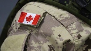 A Canadian flag is seen on the uniform of a member of the Canadian Armed Forces in Trenton, Ont., on Oct. 16, 2014. THE CANADIAN PRESS/Lars Hagberg 