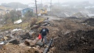 Lindsey Fudge carries groceries through the devastation left by hurricane Fiona in Burnt Island, Newfoundland on Wednesday September 28, 2022. THE CANADIAN PRESS/Frank Gunn 