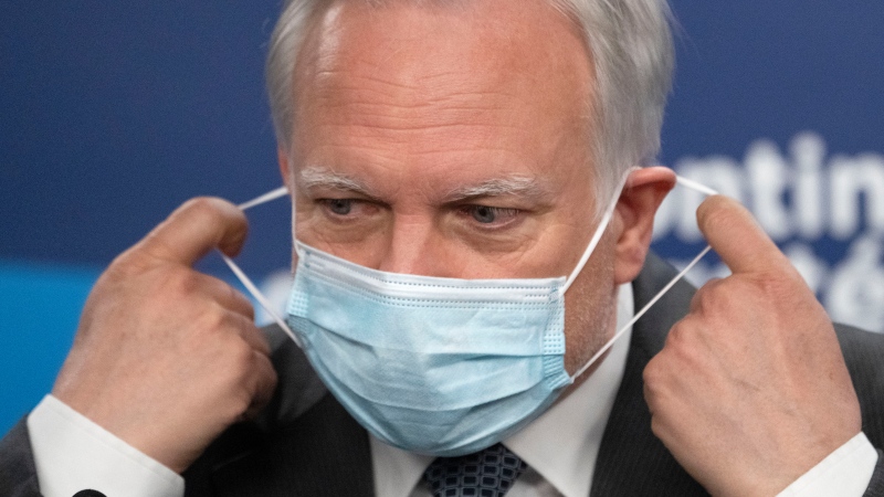 Quebec interim health director Dr. Luc Boileau removes his mask as he arrives to give a COVID-19 update, Thursday, April 21, 2022 in Montreal. The Quebec health department is recommending the extension of the mask mandate until the middle of May. THE CANADIAN PRESS/Ryan Remiorz