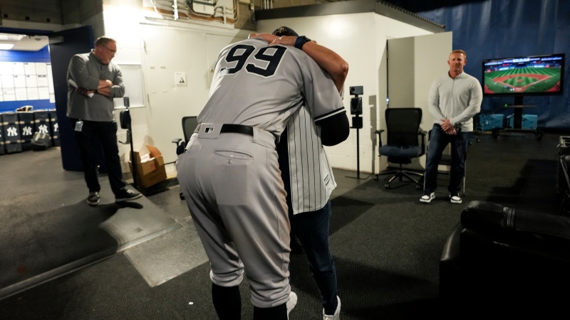New York Yankees designated hitter Aaron Judge (99) hugs his mother Patty Judge after hitting his 61st home run of the season against the Toronto Blue Jays in American League MLB baseball action in Toronto on Wednesday, September 28, 2022. THE CANADIAN PRESS/Nathan Denette