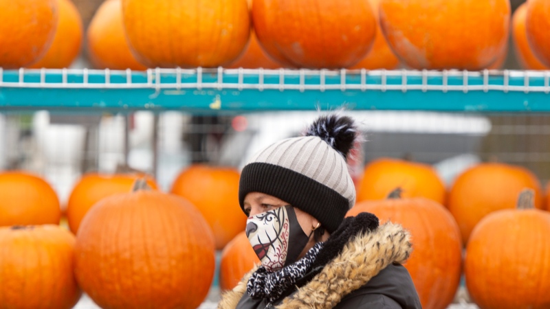 A pumpkin vendor waits for customers at a market, Wednesday, October 28, 2020 in Montreal.THE CANADIAN PRESS/Ryan Remiorz