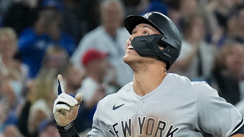 New York Yankees designated hitter Aaron Judge (99) celebrates his 61st home run of the season, a two-run shot, against the Toronto Blue Jays during seventh inning American League MLB baseball action in Toronto on Wednesday, September 28, 2022. THE CANADIAN PRESS/Nathan Denette
