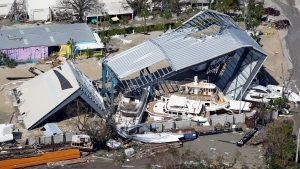 This aerial photo shows damaged boats and structures in the aftermath of Hurricane Ian, Thursday, Sept. 29, 2022, in Fort Myers, Fla. (AP Photo/Wilfredo Lee)