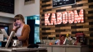 Kaboom Chicken restaurant employee Sydney Harrison takes a customer's order in Toronto on Friday, December 29, 2017. THE CANADIAN PRESS/Christopher Katsarov