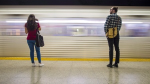 Commuters wait to take the subway at Ossington Station in Toronto. THE CANADIAN PRESS/ Tijana Martin