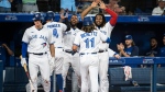 Toronto Blue Jays celebrate after Bo Bichette (11) and pitch hitter George Springer (4) score on a double by Santiago Espinal (5) during seventh inning AL MLB baseball action against the Baltimore Orioles, in Toronto on Wednesday, August 17, 2022. THE CANADIAN PRESS/Christopher Katsarov 