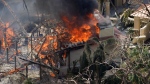 A home burns on Sanibel Island in the wake of Hurricane Ian, Thursday, Sept. 29, 2022, in Fla. (AP Photo/Wilfredo Lee) 