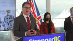 B.C. Health Minister Adrian Dix, left, speaks during an announcement on improving the province's health-care system on Sept. 29, 2022. 