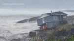 An Ontario family's iconic blue house is swept away in Hurricane Fiona's path in Port aux Basques, N.L. (Courtesy: R. Roy Wreckhouse Press)