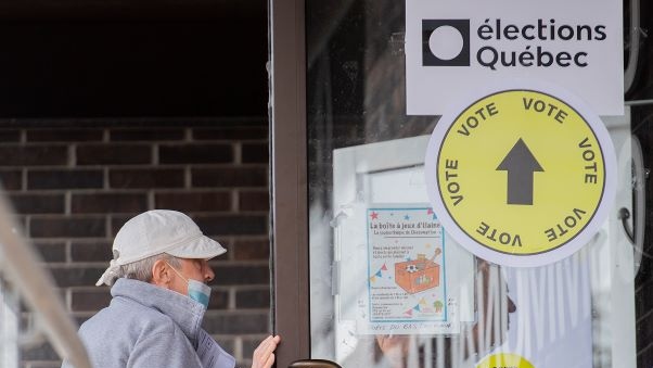 People enter a polling station in L'Assomption, Que., Sunday, September 25, 2022, as advanced polling begins ahead of the the Quebec election on October 3rd. THE CANADIAN PRESS/Graham Hughes