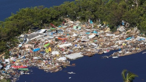 Debris is piled up at the end of a cove following heavy winds and storm surge caused by Hurricane Ian Thursday, Sept. 29, 2022, in Barefoot Beach, Fla. (AP Photo/Marta Lavandier) 