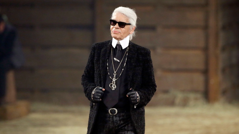 In this Tuesday, Dec. 10, 2013 file photo, Chanel designer Karl Lagerfeld takes a bow at the end of his Metiers d'Art fashion show in Dallas. (AP Photo/Tony Gutierrez, File)