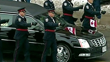 Officers march beside the hearse carrying the body of Const. Eric Czapnik through Ottawa to the funeral, Thursday, Jan. 7, 2010.