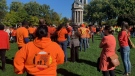 Thousands seen wearing orange shirts.