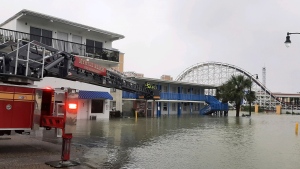 This photo provided by the Myrtle Beach Fire Dept., crews respond to rescue people who were trapped on the second floor due to flooding caused by Hurricane Ian, on Friday, Sept. 30, 2022 in Myrtle Beach, S.C. (Myrtle Beach Fire Dept. via AP)