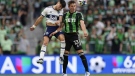 Vancouver Whitecaps FC midfielder Ryan Raposo, left, and Austin FC midfielder Ethan Finlay (13) leap for the ball during the first half of an MLS soccer match on April 23, 2022, in Austin, Texas. THE CANADIAN PRESS/AP, Eric Gay
