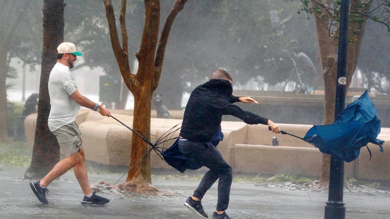 Wind gusts, blowing down King Street, twist umbrellas during Hurricane Ian in Charleston, S.C., on Friday, Sept. 30, 2022. (Grace Beahm Alford/The Post and Courier via AP)