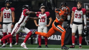 B.C. Lions' Dominique Rhymes, right, makes the reception as Ottawa Redblacks' Brandin Dandridge defends during the first half of CFL football game in Vancouver, on Friday, September 30, 2022. THE CANADIAN PRESS/Darryl Dyck