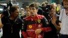 Ferrari driver Charles Leclerc of Monaco walks after clocking the fastest time in the qualifying session at the Singapore Formula One Grand Prix, at the Marina Bay City Circuit in Singapore, Saturday, Oct. 1, 2022. (AP Photo/Vincent Thian)