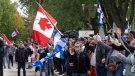 People take part in a protest against the Coalition Avenir du Quebec government of Francois Legault in his home riding Saturday, October 1, 2022 in L’Assomption, Quebec. Quebec votes in the provincial election Oct. 3, 2022.THE CANADIAN PRESS/Ryan Remiorz